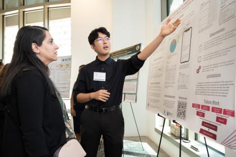 Student presenting research poster