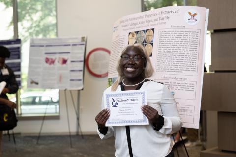 Princess Ochweri, 1st place overall winner, next to her research poster