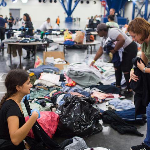 People gather at an emergency shelter during an emergency.